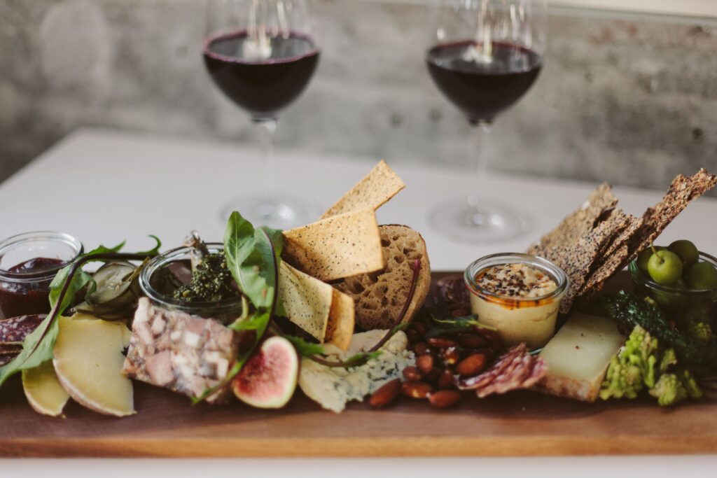 A gourmet charcuterie board paired with red wine, ideal for fine dining.